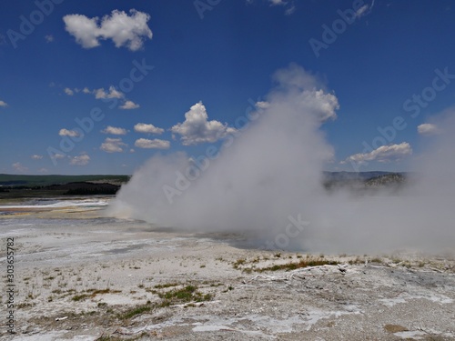 Hot steam rises from the Clepsydra Geyser at the Lower Geyser Basin, Yellowstone National Park.