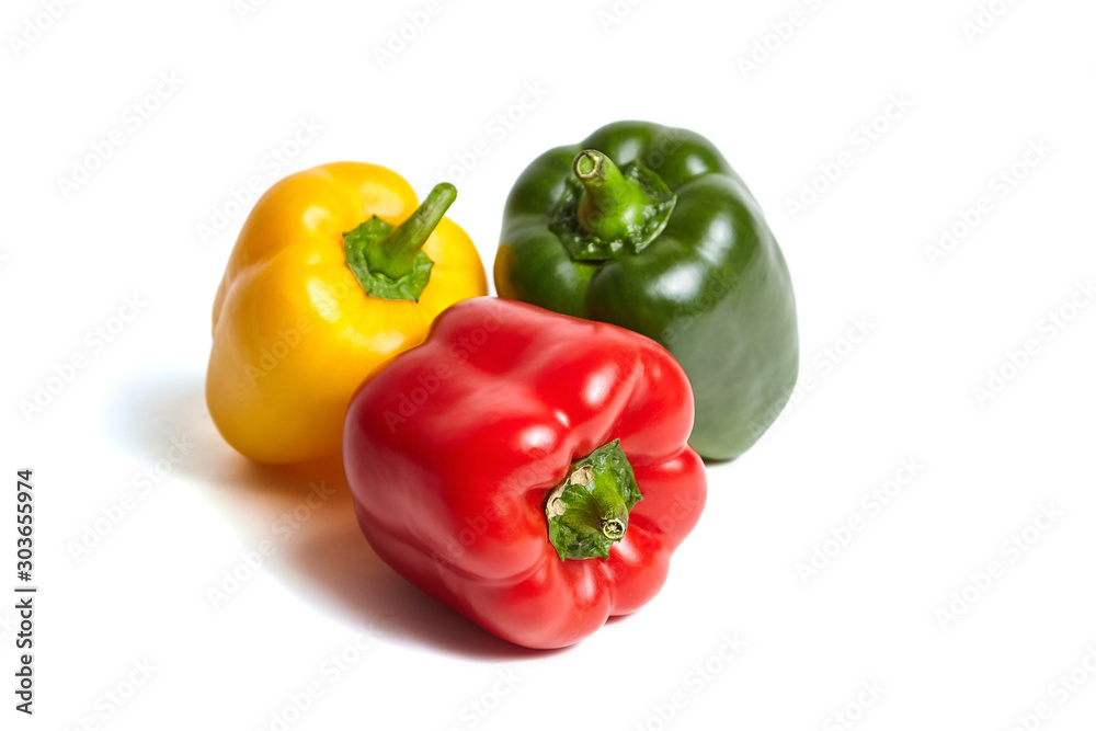 Red, green, and yellow bell peppers isolated on white background. Sweet peppers in different colors, vegetable ingredient, healthy food