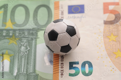 Soldi euro e palla da calcio - calcio mercato e scommesse calcistiche  photo