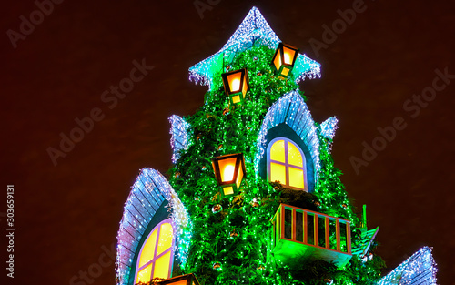 Lithuanian Christmas tree situated at Cathedral Square in Vilnius, Lithuania. It looks like a big house. Winter. Street and holiday fair in European city Advent Decoration with Craft Items on Bazaar
