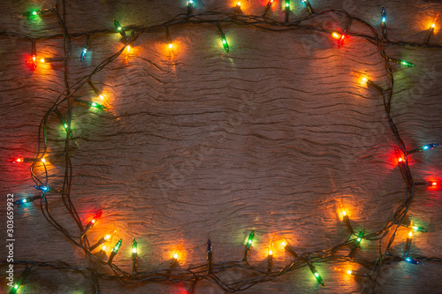 Christmas lights on wooden plank background. Merry Christmas and happy new year with copy space for a text...