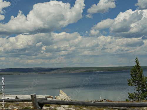 Medium wide shot of gorgeous white clouds over the Yellowstone Lake at Yellowstone National Park  Wyoming  USA.