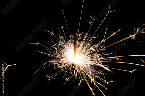 Close-up of bright Bengal lights on black background.