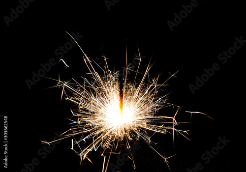 Close-up of bright Bengal lights on black background.