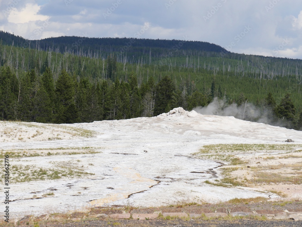 Old Faithful geyser at Yellowstone National Park in between eruptions. The geyser erupts every 90 minutes and is the most popular attraction at the park.