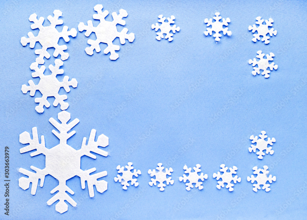 Christmas or winter composition. Pattern made of white snowflakes on blue background. Christmas or winter composition. Pattern made of white snowflakes on blue background.