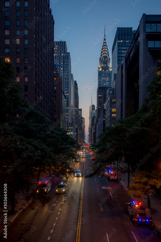 A view of a busy street at night in a city A view of a busy street at night in a city