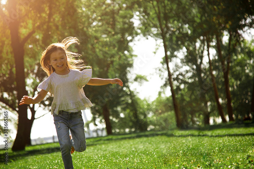 Bild auf Leinwand full length shot of happy girl running in the park alone