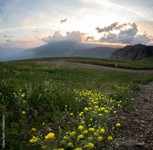 sunset in the mountains of flowers, stones and sun