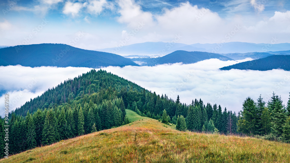 Foggy summer scene of Carpathian mountains. Fantastic morning landscape of Lisniv ridge, Ukraine, Europe. Picturesque outdoor scene of mountain valley. Beauty of nature concept background.. Foggy summer scene of Carpathian mountains. Fantastic morning landscape of Lisniv ridge, Ukraine, Europe. Picturesque outdoor scene of mountain valley. Beauty of nature concept background..