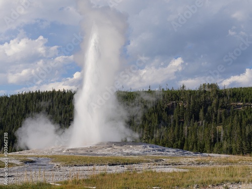 Colums of scalding water and steam spurts out of the Old Faithful geyser as high as 180 feet at Yellowstone National Park, Wyoming.