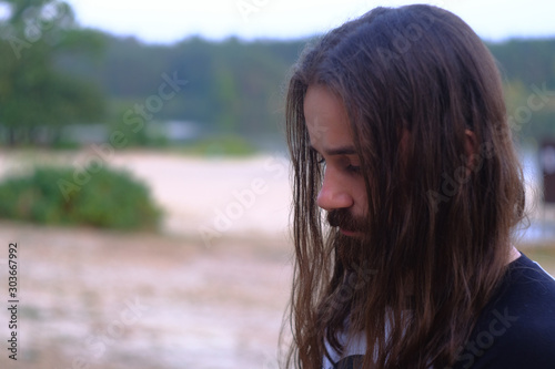 Photos Portrait of handsome bearded young man with long hair