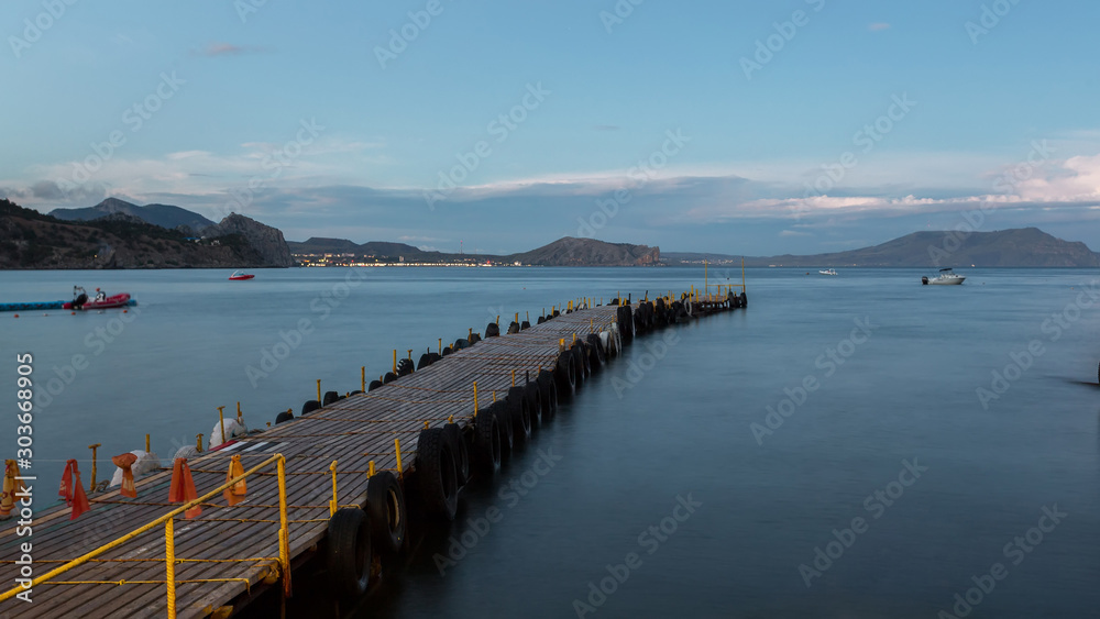 mooring in the bay, floating pier, a long pier