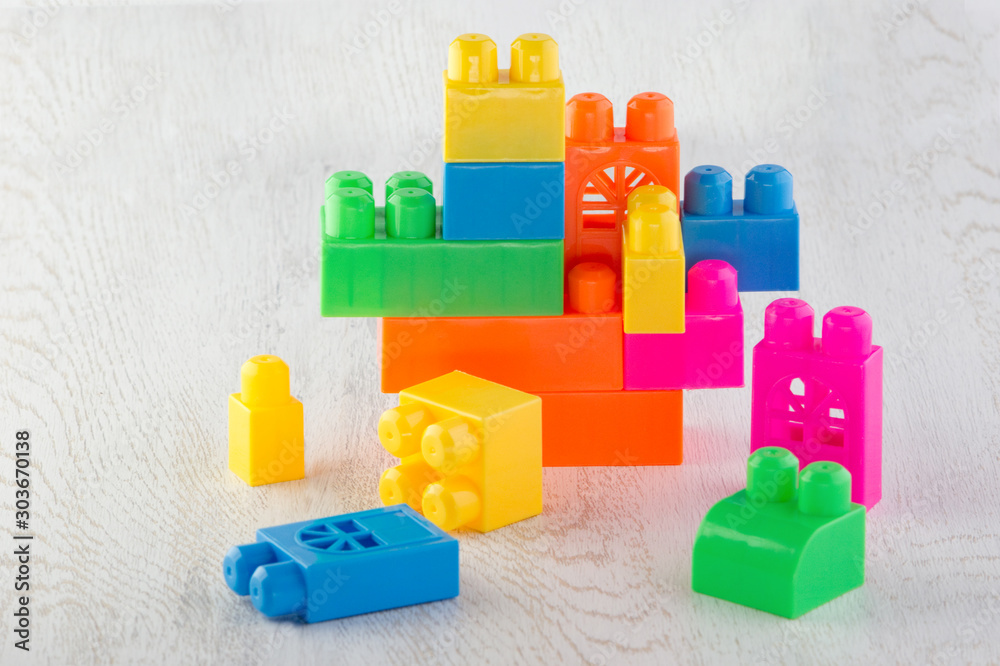 details of the children's designer of different colors and shapes folded on each other on a wooden tabletop details of the children's designer of different colors and shapes folded on each other on a wooden tabletop