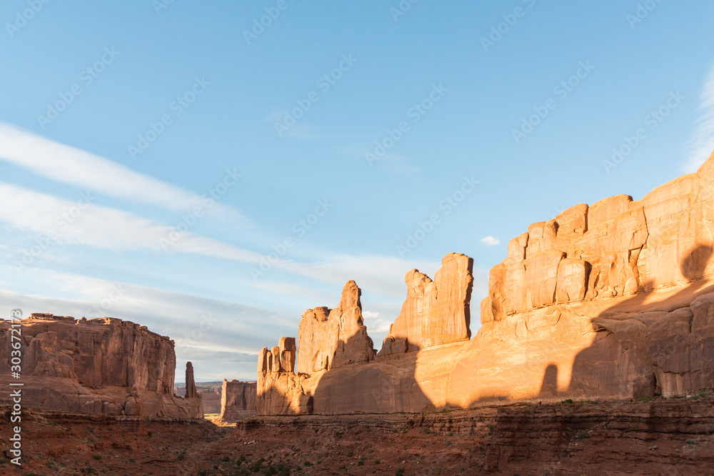Park Avenue in Arches National Park. A wall made by rock formations with shadows and sunset lights