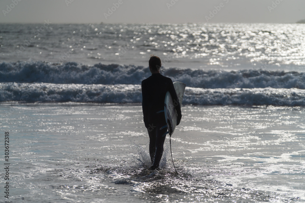 Surfer entering ocean Surfer entering ocean
