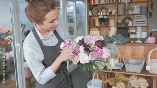 Florist making fresh flower bouquet in flower shop