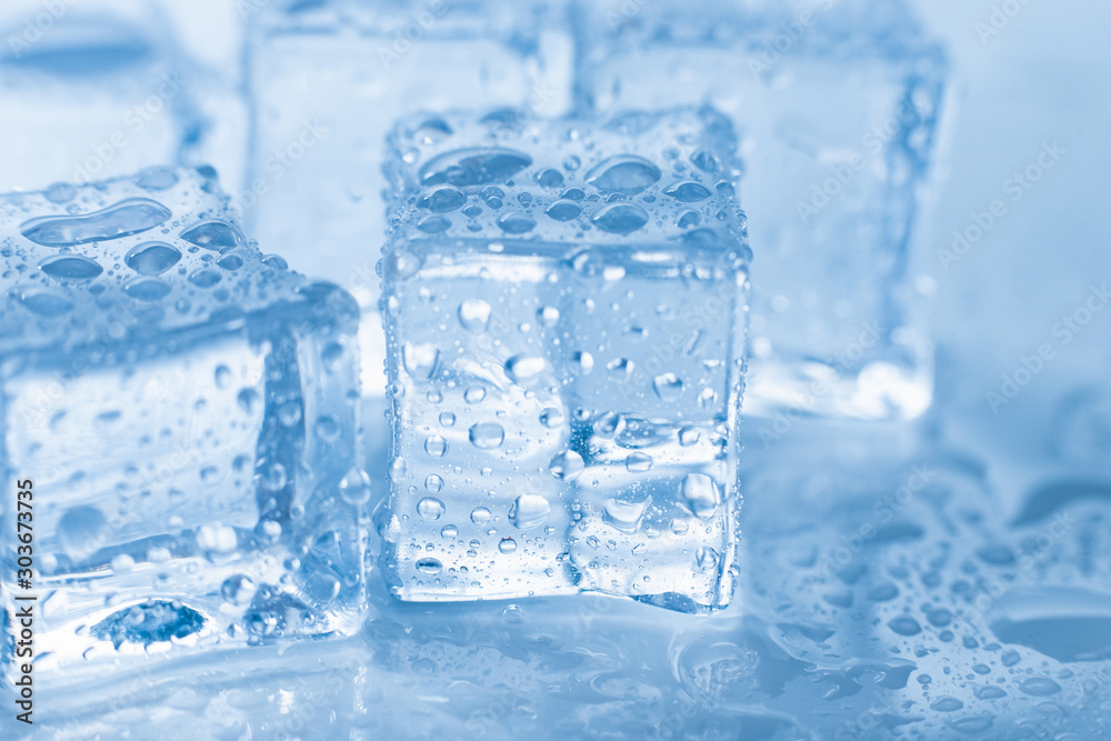 Ice cubes macro square with drops water clean on blue background Ice cubes macro square with drops water clean on blue background