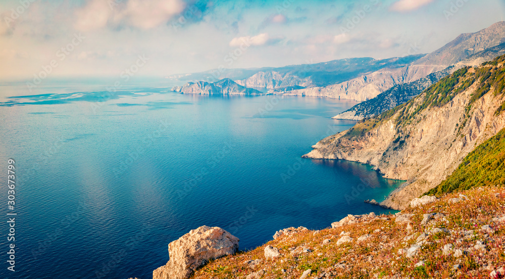 Misty summer view of Asos peninsula and town. Aerial morning seascape of Ionian Sea. Breathtaking outdoor scene of Kephalonia island, Greece, Europe. Traveling concept background.