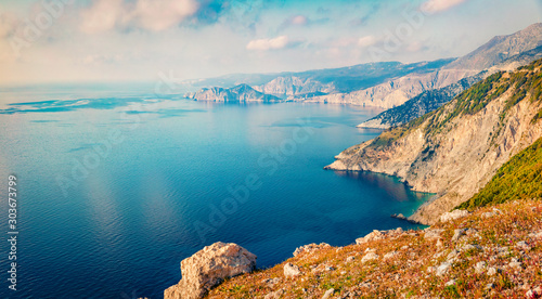 Misty summer view of Asos peninsula and town. Aerial morning seascape of Ionian Sea. Breathtaking outdoor scene of Kephalonia island, Greece, Europe. Traveling concept background.