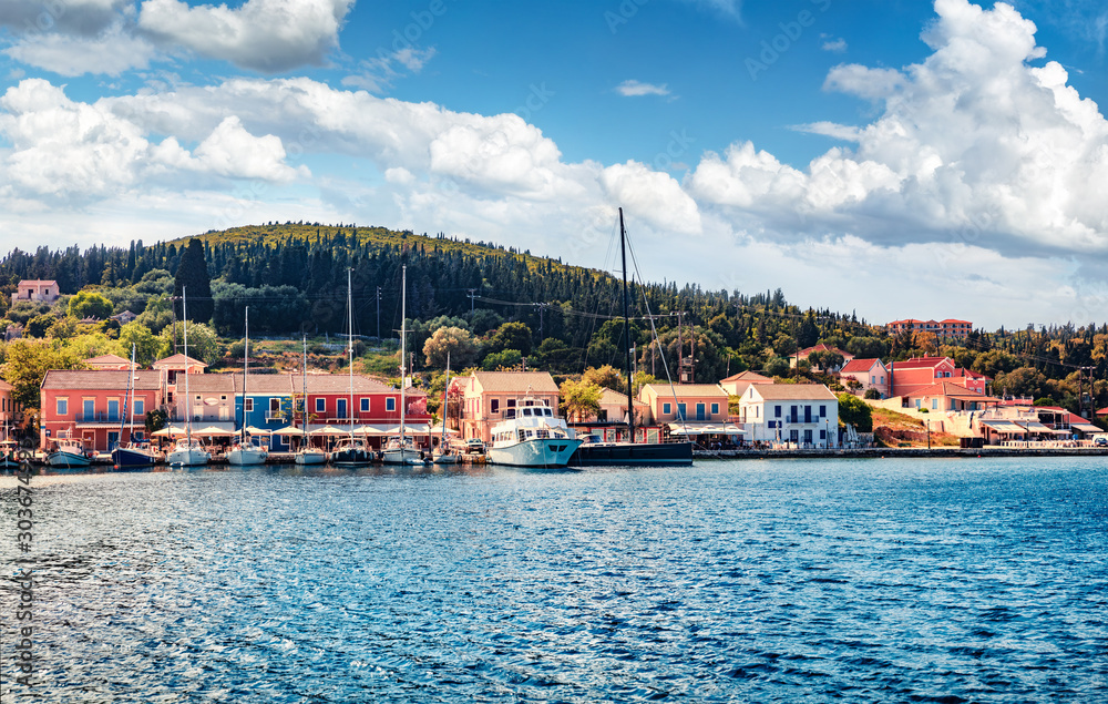 Fototapeta premium Amazing summer view of port Fiskardo. Captivating morning seascape of Ionian Sea. Stunning outdoor scene of Kefalonia island, Greece, Europe. Traveling concept background.