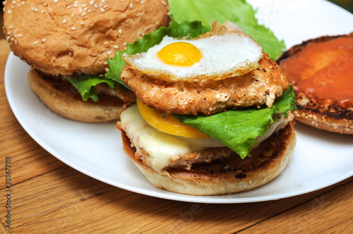 homemade fish burger. on wooden background