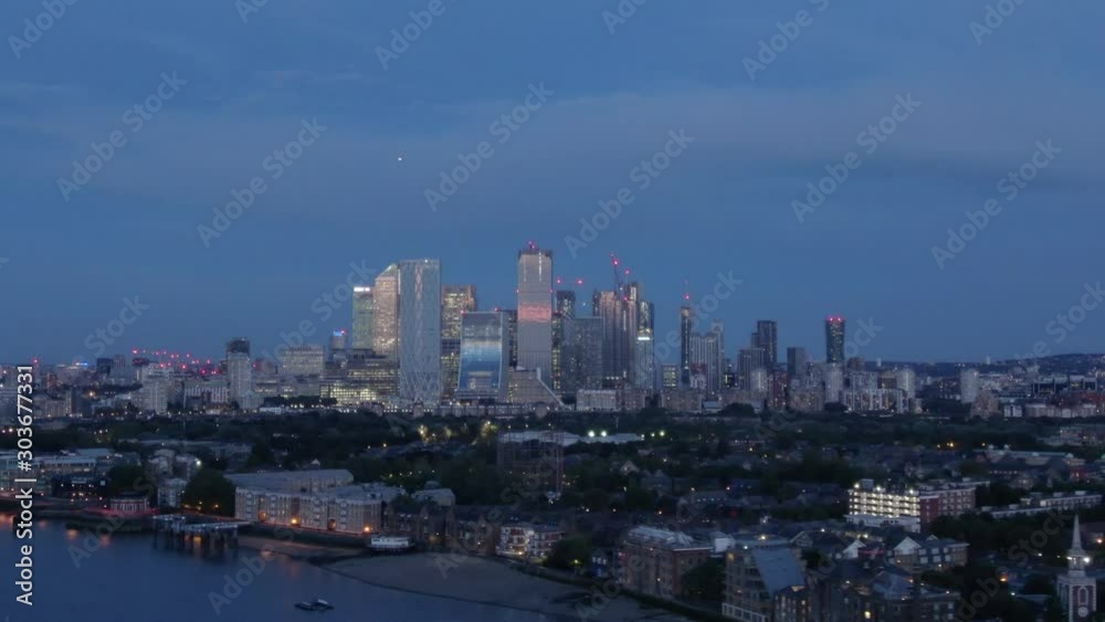 Aerial drone distant view of Canary Wharf Central Business District Towers of London's Docklands Isle of Dogs Canada Square Skyline at dusk Aerial drone distant view of Canary Wharf Central Business District Towers of London's Docklands Isle of Dogs Canada Square Skyline at dusk