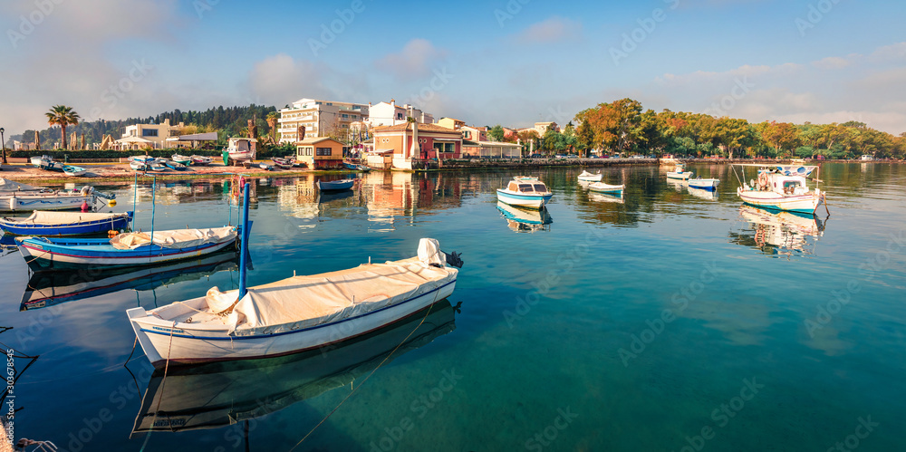 Bright panoramic view of old Kerkira port, capital of Corfu island, Greece, Europe. Sunny summer seascape of Ionian sea. Traveling concept background.