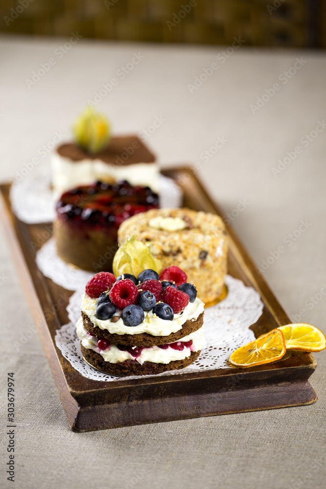 berry cake, lemon cake, cheesecake, desserts on a tray berry cake, lemon cake, cheesecake, desserts on a tray