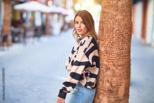 Young beautiful woman smiling happy and confident. Standing and walking at town street