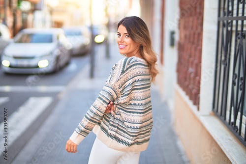 Young beautiful woman smiling happy and confident. Standing and walking at town street