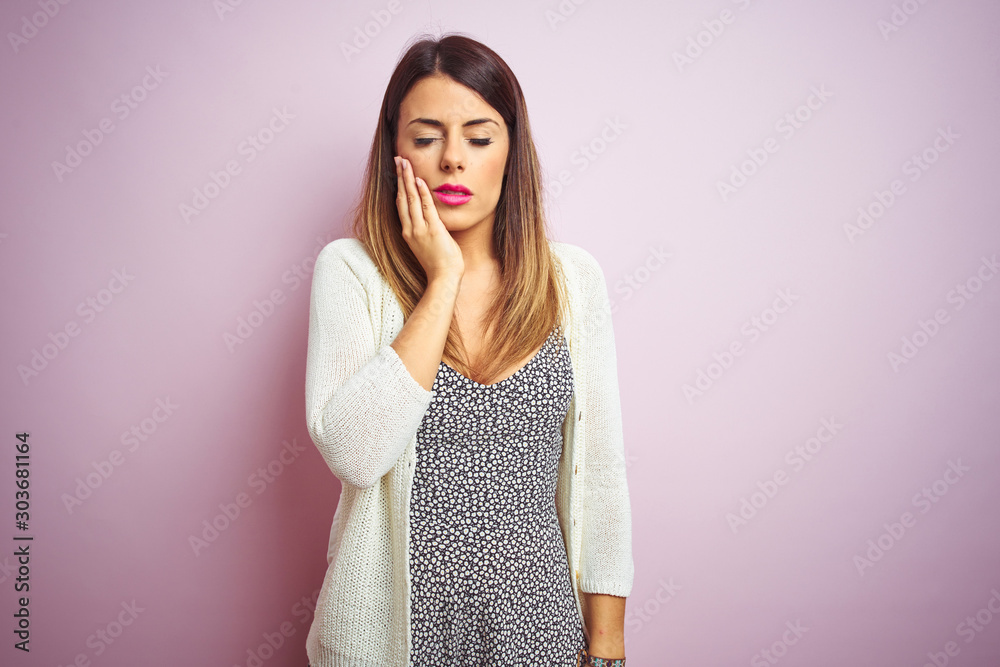 Φωτογραφία Young beautiful woman standing over pink isolated background touching mouth with hand with painful expression because of toothache or dental illness on teeth