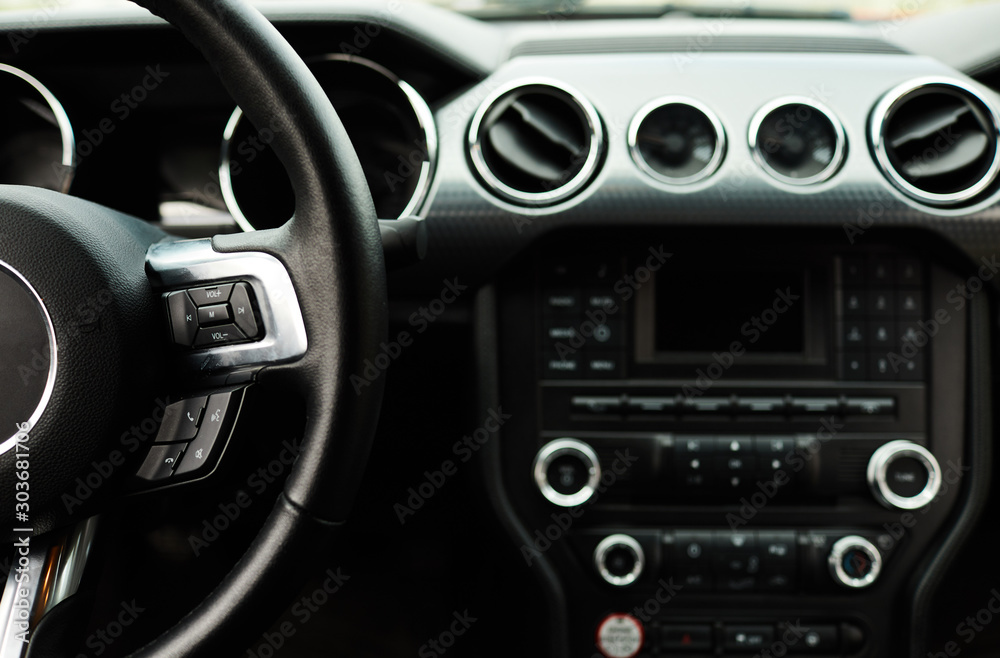 Car inside. Modern sport car Interior - steering wheel, shift lever and dashboard.