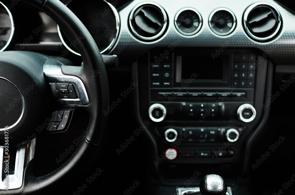 Car inside. Modern sport car Interior - steering wheel, shift lever and dashboard.