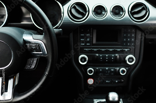 Car inside. Modern sport car Interior - steering wheel, shift lever and dashboard. © VAKSMANV