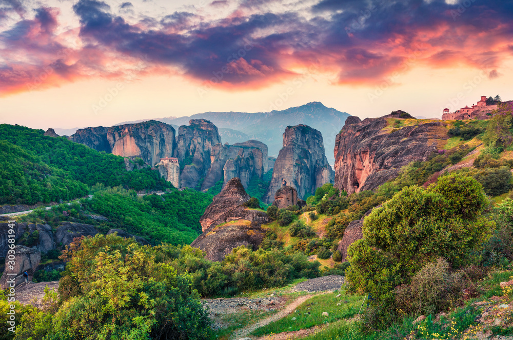 Famous Eastern Orthodox monasteries listed as a World Heritage site, built on top of rock pillars. Picturesque spring sunset in Kalabaka, Greece, Europe. Traveling concept background.