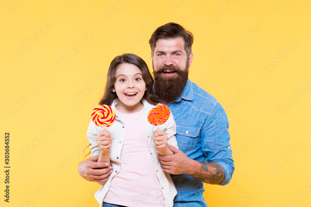 happy childhood. Daughter and father eat candy. bearded hipster man is good dad. little girl child and dad hold colorful lollipops. Sweets and treats. summer vibes. happy family. Lovely surprise happy childhood. Daughter and father eat candy. bearded hipster man is good dad. little girl child and dad hold colorful lollipops. Sweets and treats. summer vibes. happy family. Lovely surprise