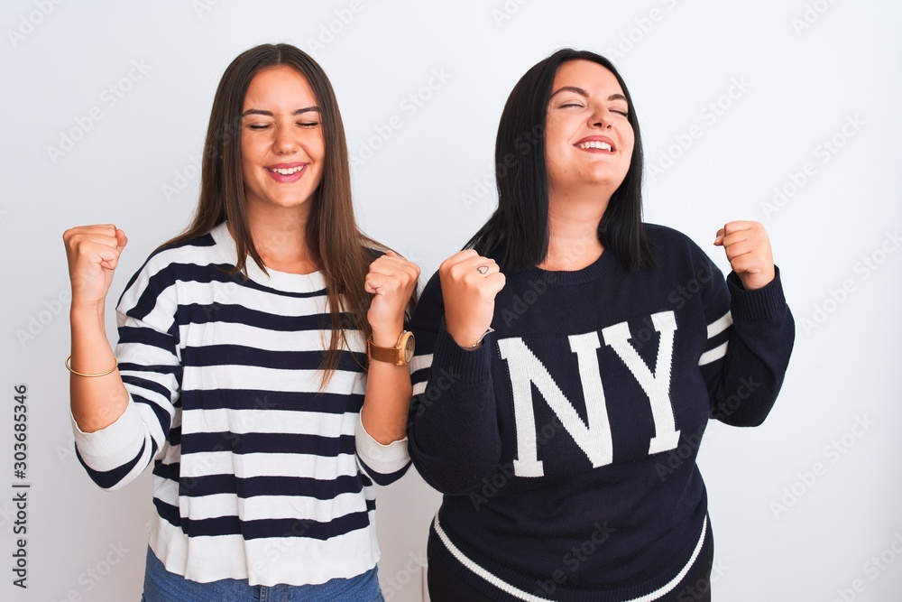 Φωτογραφία Young beautiful women wearing casual clothes standing over isolated white background very happy and excited doing winner gesture with arms raised, smiling and screaming for success