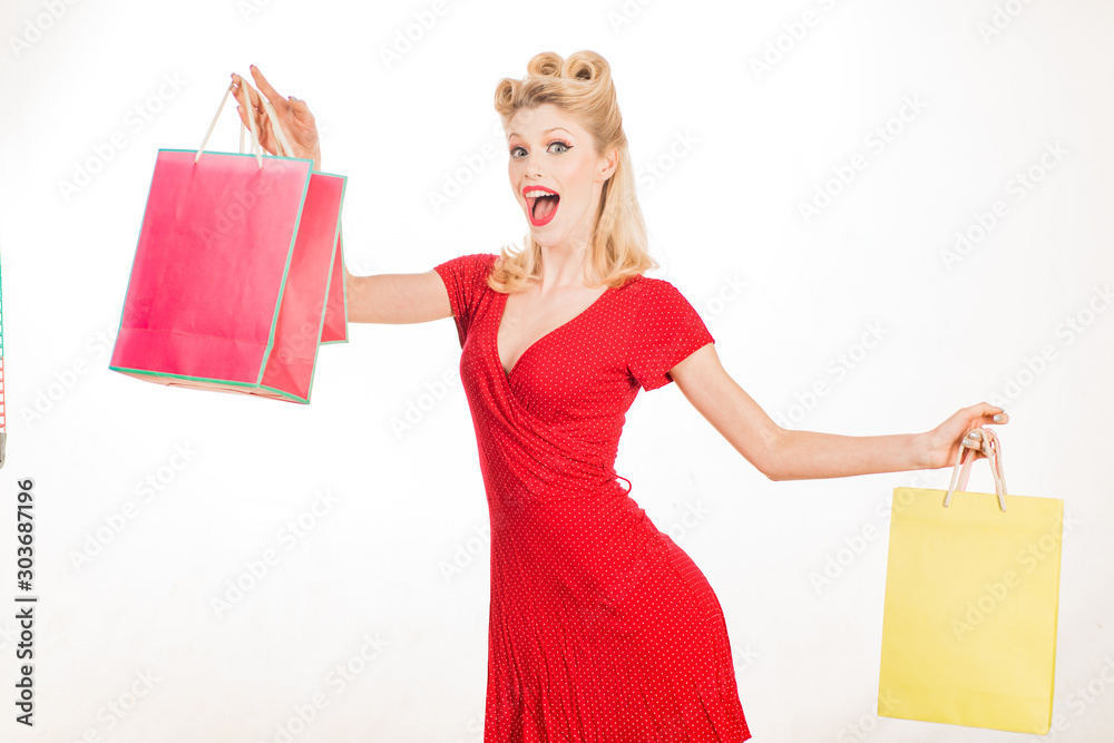 Φωτογραφία Portrait woman in pin up style red dress holding shopping bags