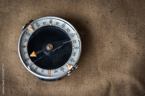 Military compass. on green tarpaulin.