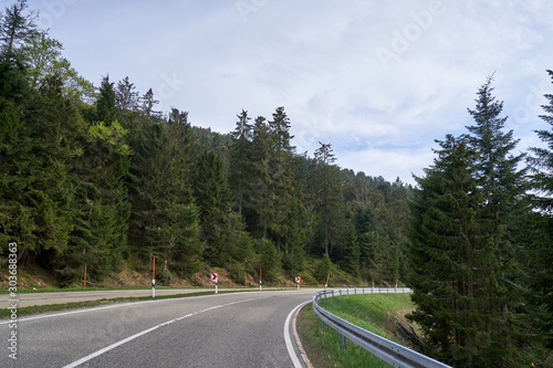 Beautiful asphalt road with turns through the coniferous forest of the Schwarzwald in Germany