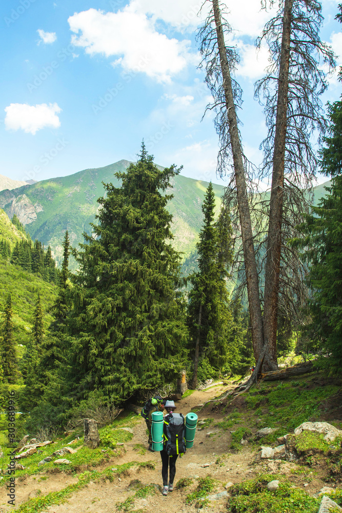 trekking in the mountains, people with backpacks, tian shan, Kyrgyzstan
