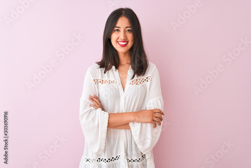 Young chinese woman wearing summer shirt standing over isolated pink background happy face smiling with crossed arms looking at the camera. Positive person.