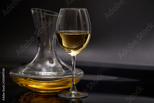 A glass full of wine and wine decanters