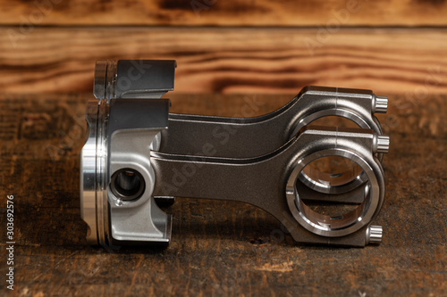 high performance motorcycle engine parts on a workbench. pistons connecting rods clutch and tools 