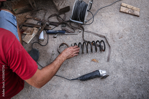 Obraz na plátne Cutting springs on a car using an angle grinder