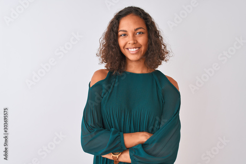 Young brazilian woman wearing green t-shirt standing over isolated white background happy face smiling with crossed arms looking at the camera. Positive person. photo