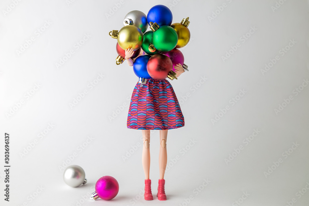 Φωτογραφία Christmas or new year abstract made of doll carrying multicolored decoration balls winter holidays concept