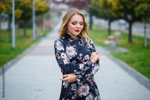 Beautiful girl in a dress on a city alley