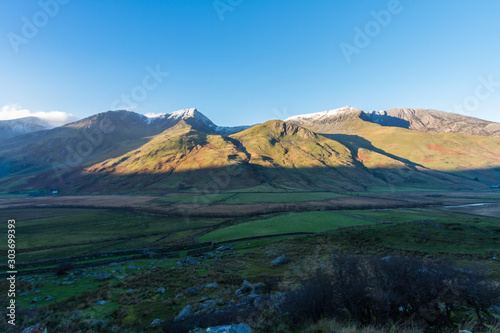 Early morning light and shadow over mountains and snow. Foel Goch and mynydd perfedd, Snowdonia. photo